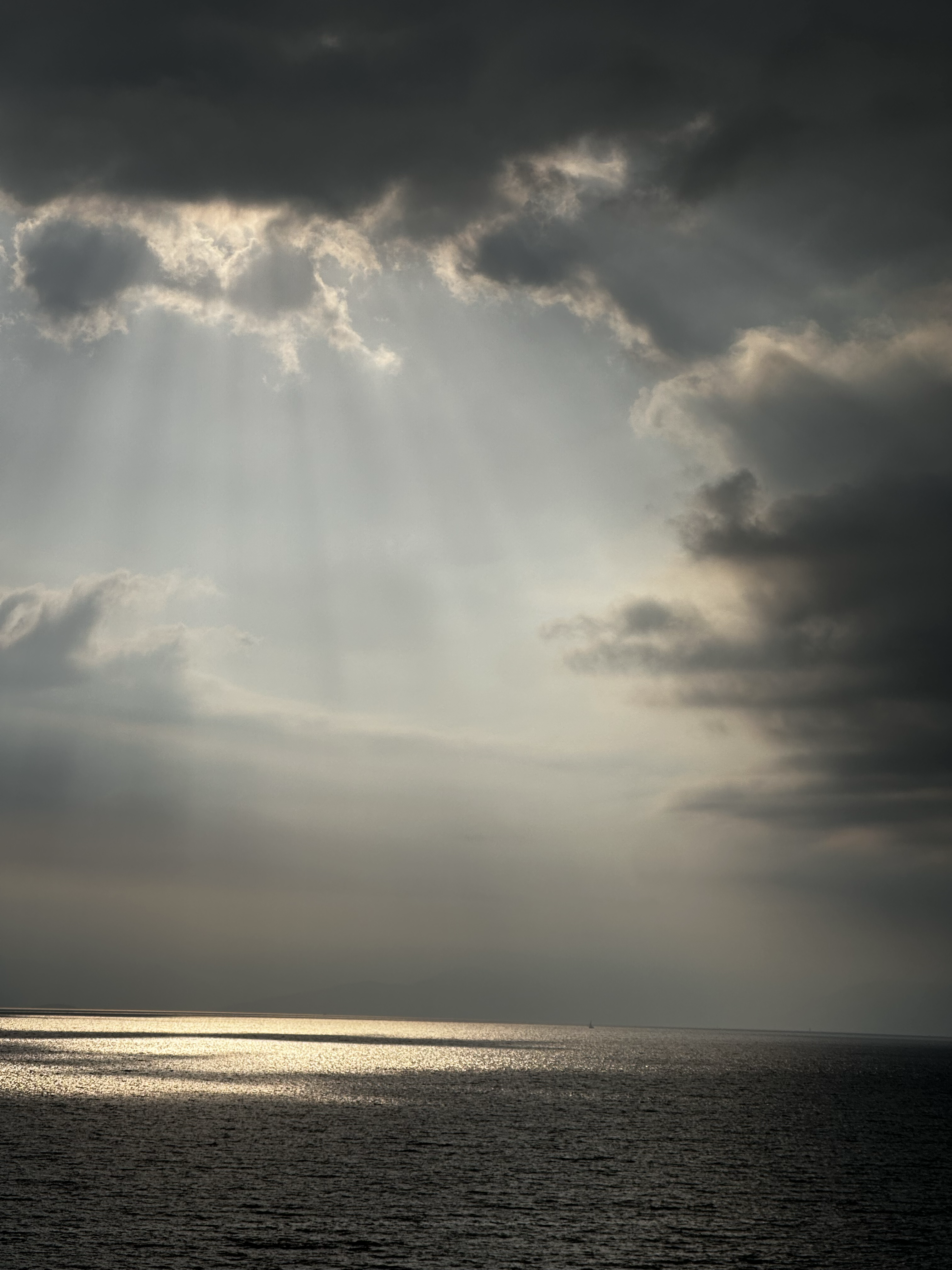 1530-sun-rays-through-clouds-over-sea-black-beige-portrait-paul-underwood-original-work.png